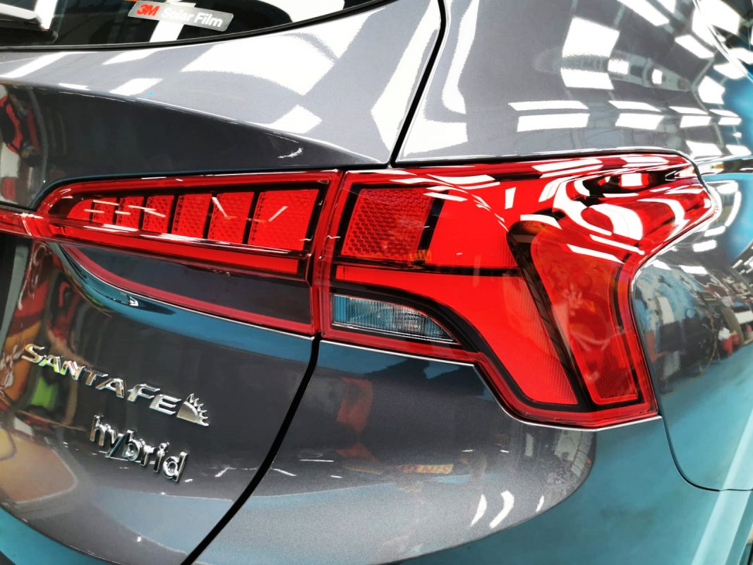 The coated bonnet of the Hyundai Santa Fe under workshop lighting.