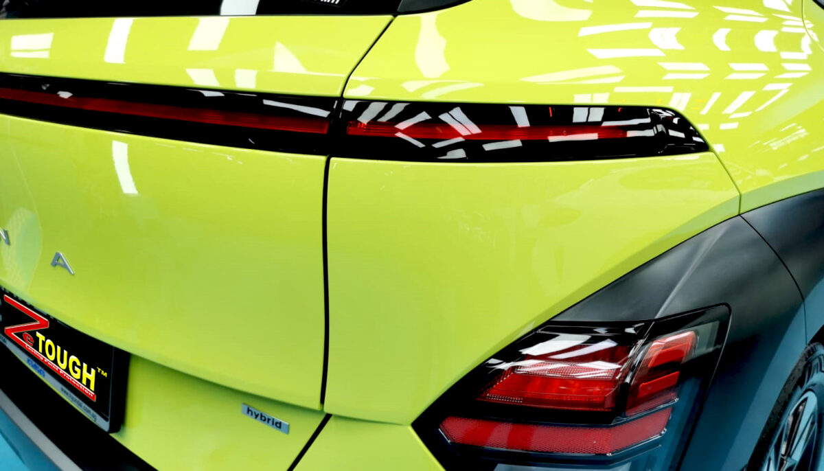 The coated bonnet of the Hyundai SX2 Kona under workshop lighting.