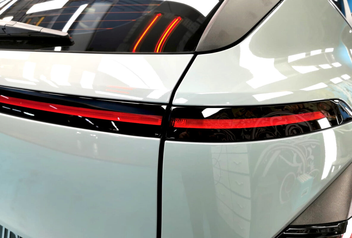 The coated bonnet of the Hyundai SX2 Kona under workshop lighting.