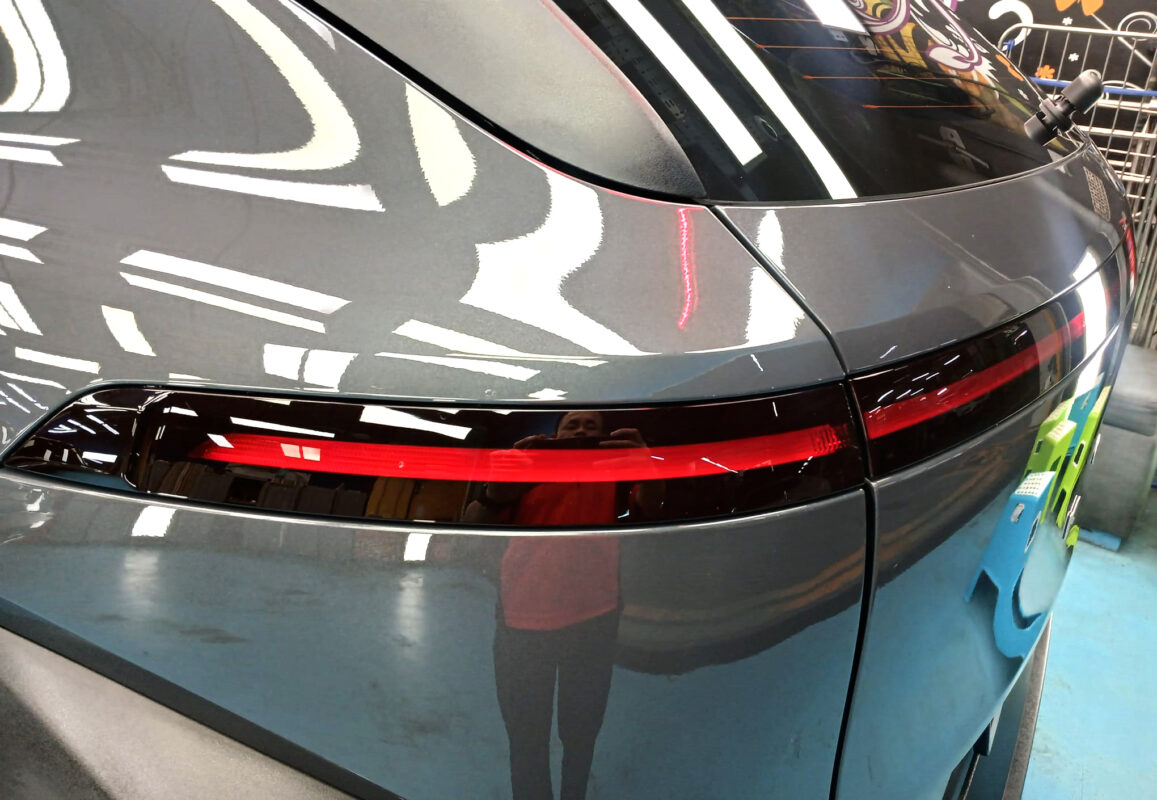 The coated bonnet of the Hyundai Kona under workshop lighting.