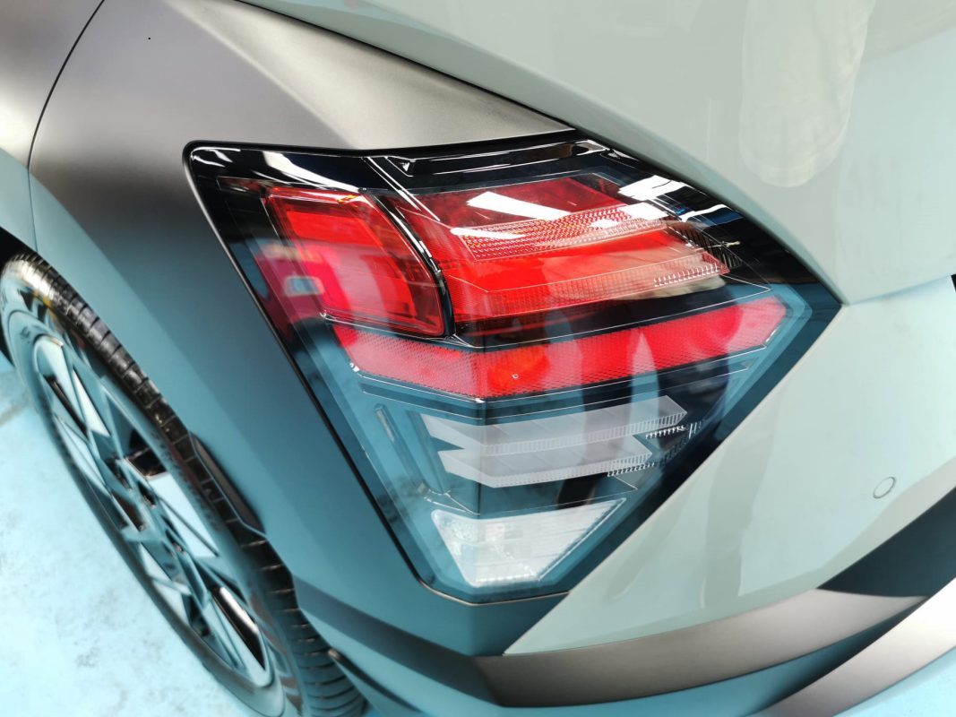 The coated bonnet of the Hyundai Kona under workshop lighting.
