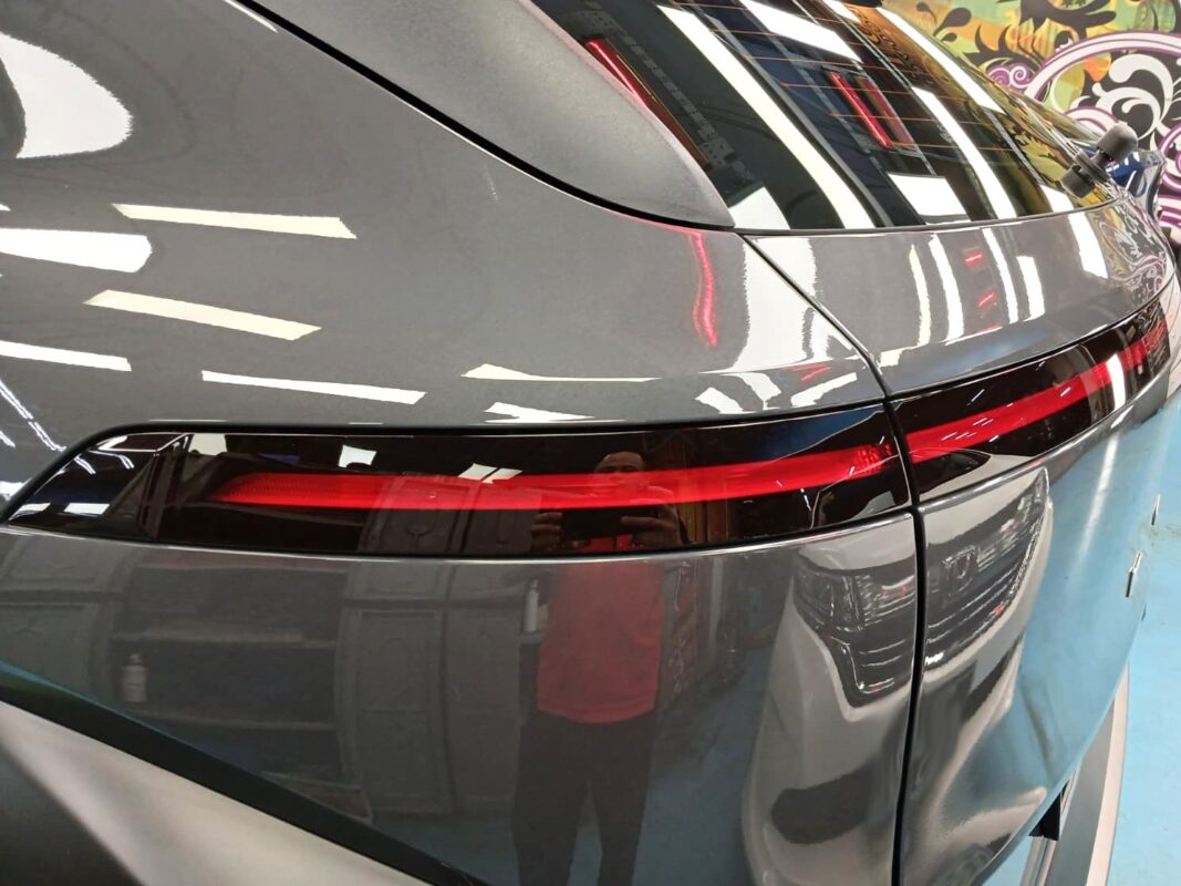 The coated bonnet of the Hyundai SX2 Kona under workshop lighting.