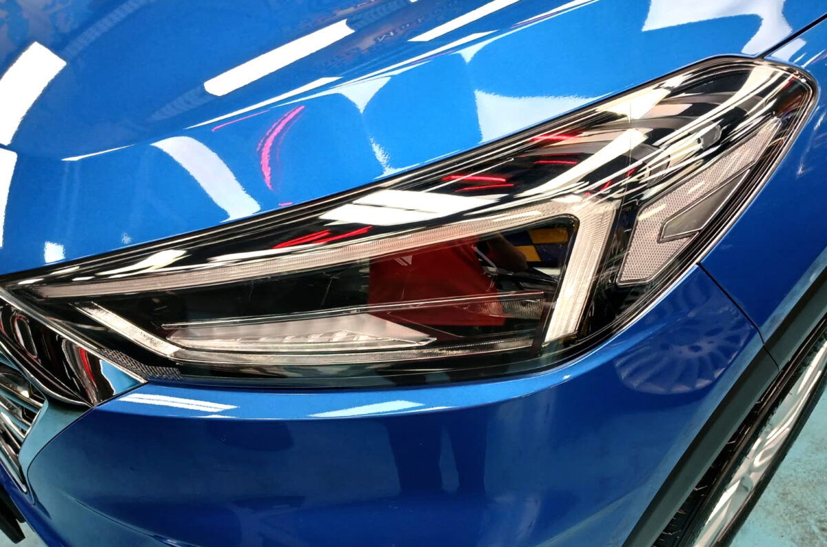 The Tucson's coated paintwork holding clean reflections.
