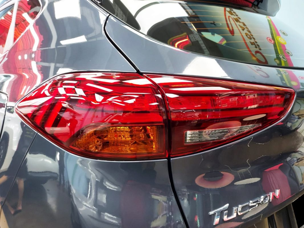 Coated bonnet of the Hyundai TL Tucson under workshop lighting.