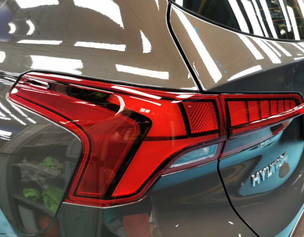 The coated bonnet of the Hyundai TM Santa Fe under workshop lighting.
