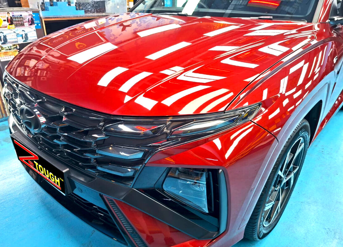 The Hyundai Tucson's coated paintwork under workshop lighting.