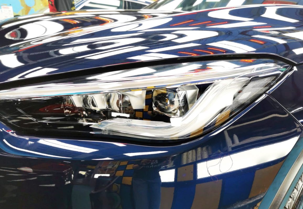 The QX50's coated paintwork showing clean reflections.