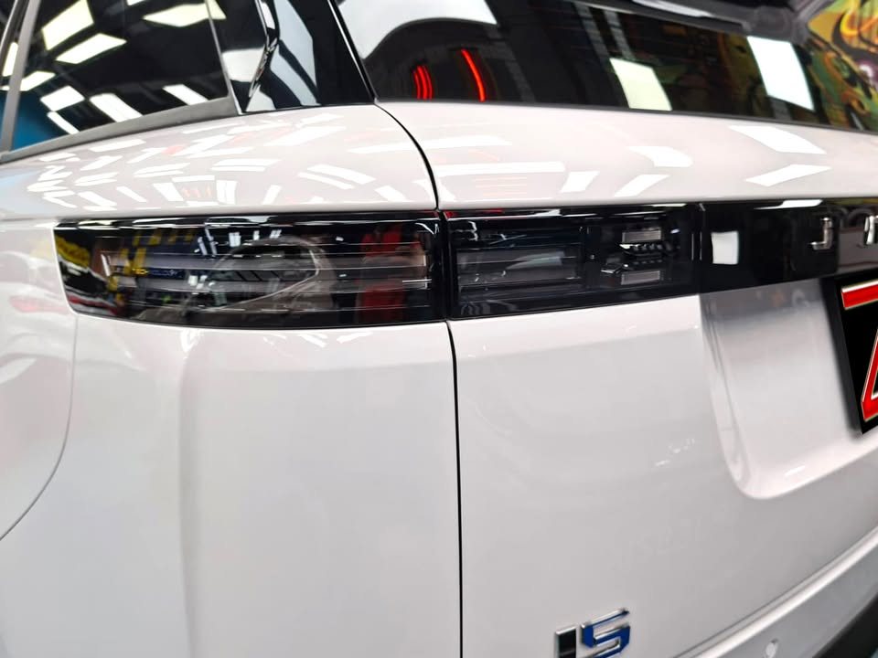 Close-up of the J5 tail light bar on white bodywork.