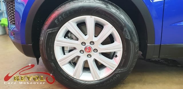 The coated bonnet of the Jaguar E-Pace under workshop lighting.