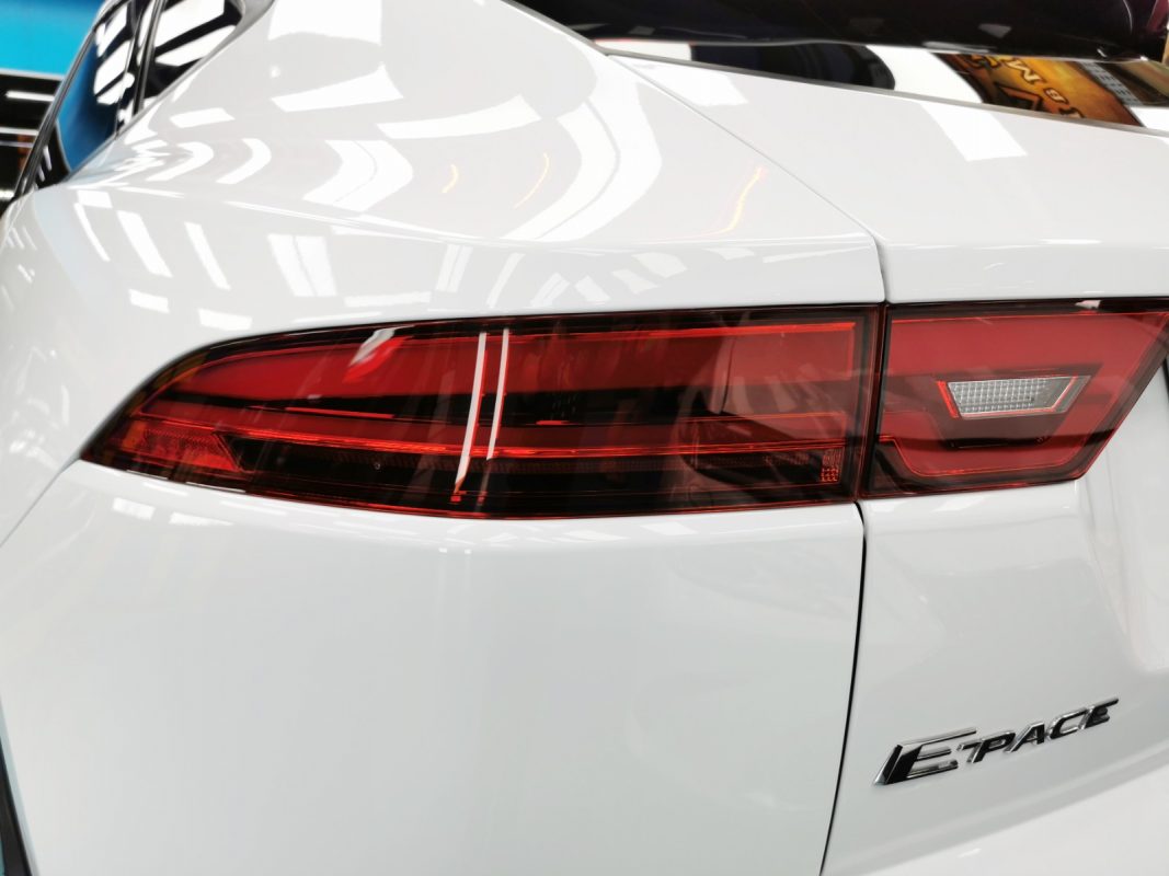 The coated bonnet of the Jaguar E-Pace under workshop lighting.