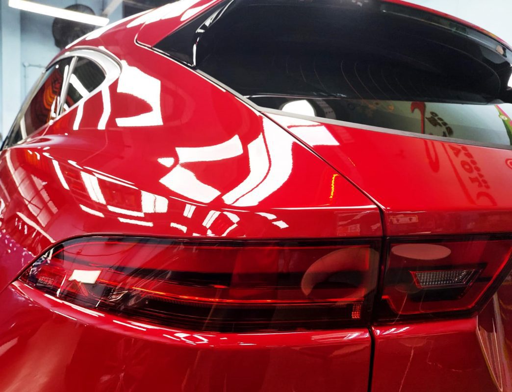 The coated bonnet of the Jaguar E-Pace under workshop lighting.