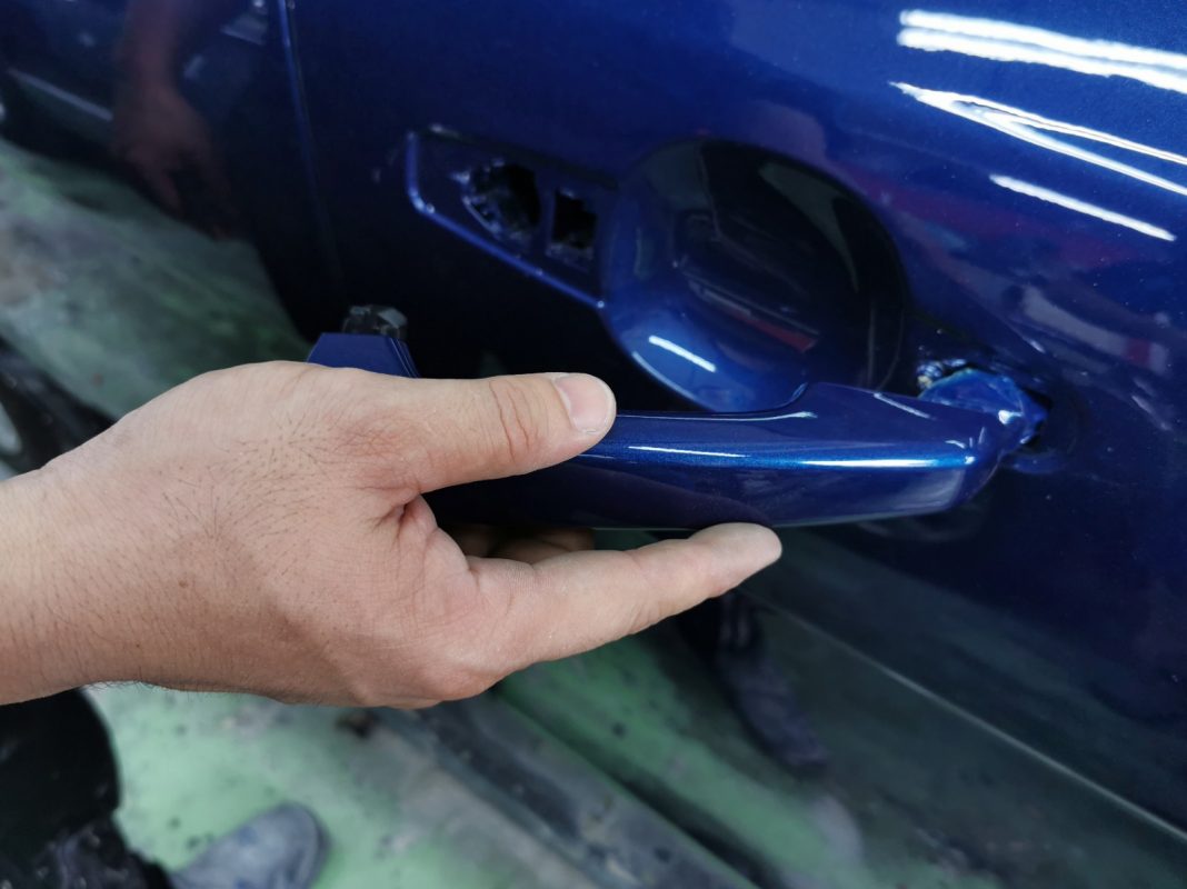Buffing the new paint on the XE to bring up the shine.