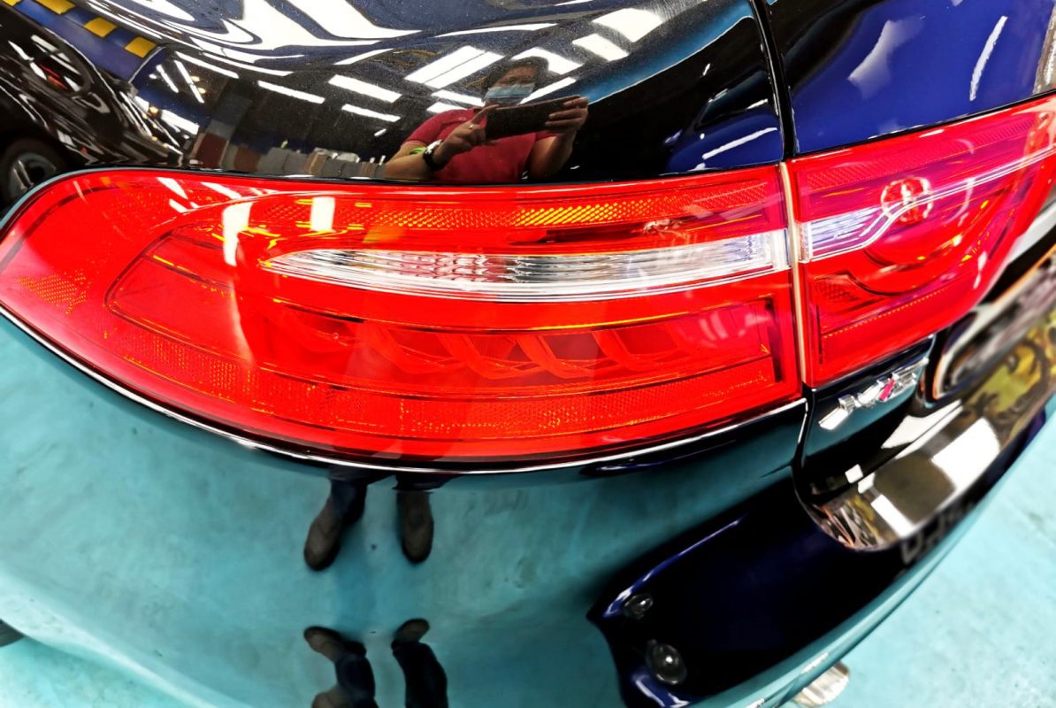The coated bonnet of the Jaguar XE under workshop lighting.
