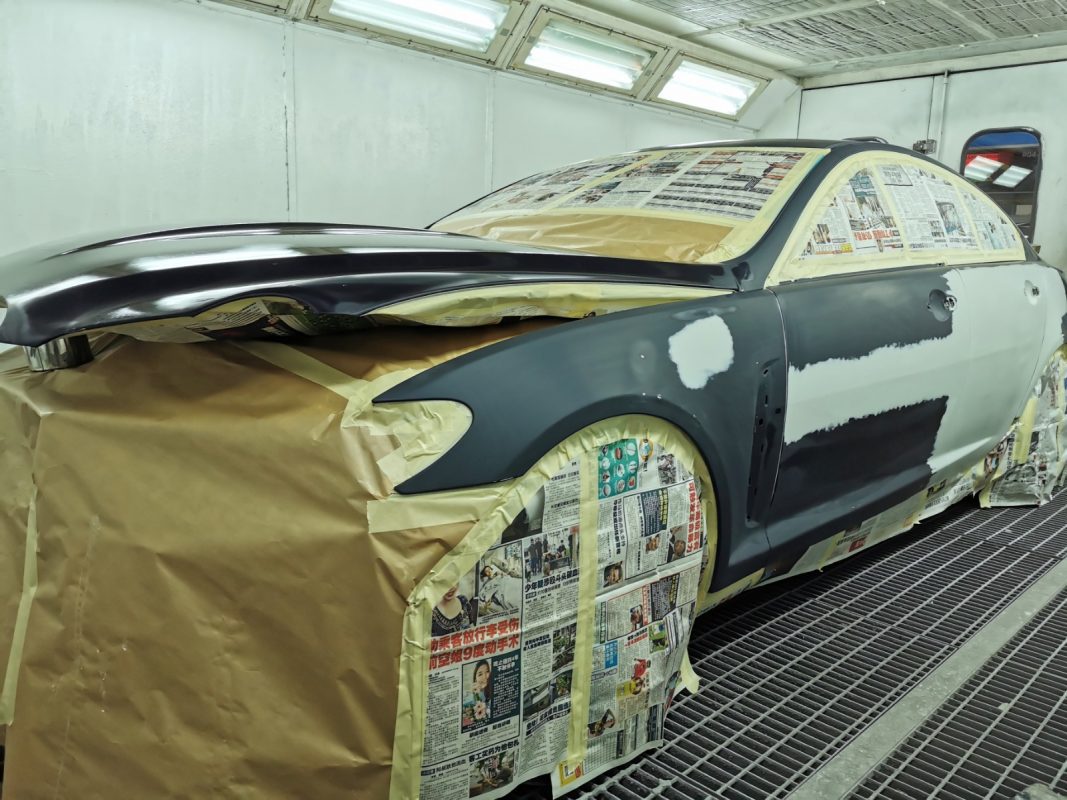 Non-painted surfaces being masked off on the XF before spraying.