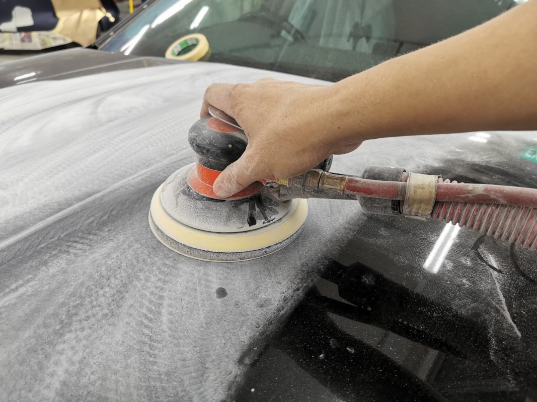 The car's surface inspected and patched where the paintwork was imperfect.