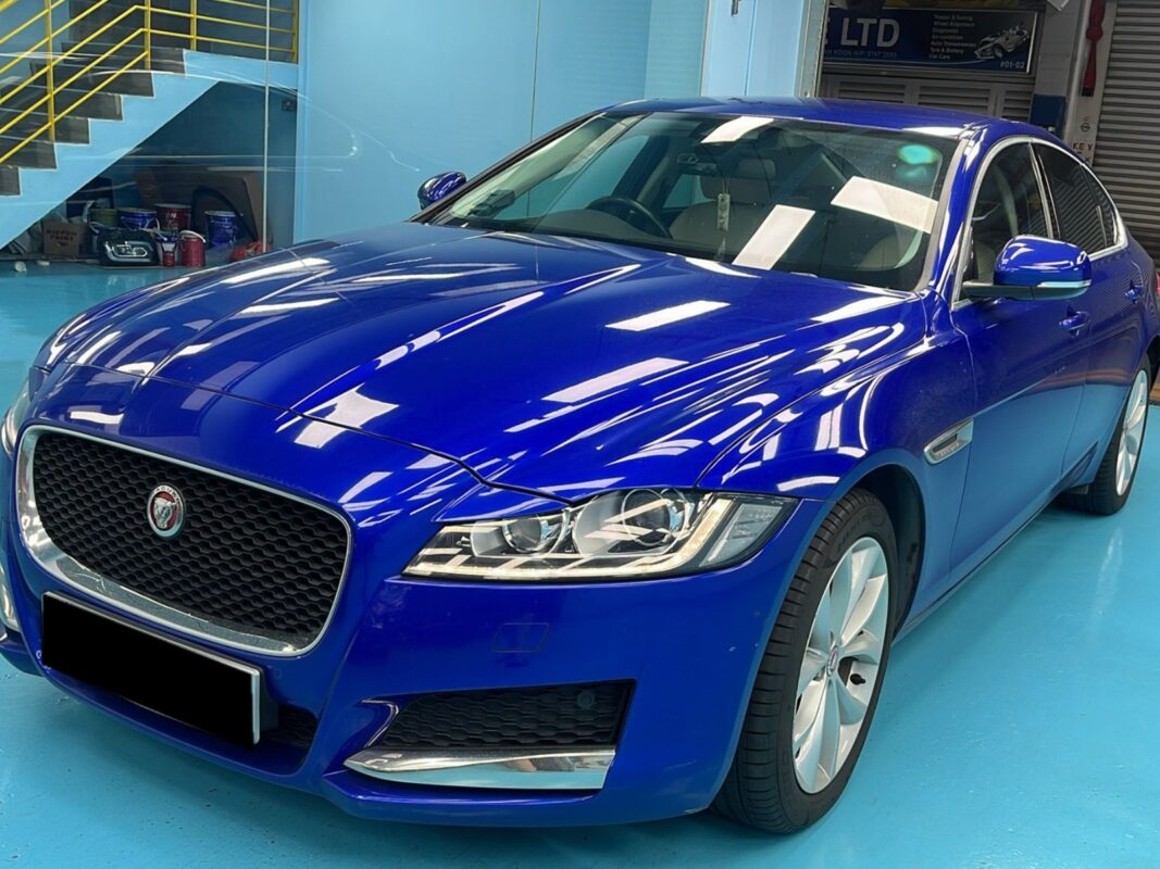 The Jaguar XF as it arrived at Revol Carz, paintwork dull and stonechipped.