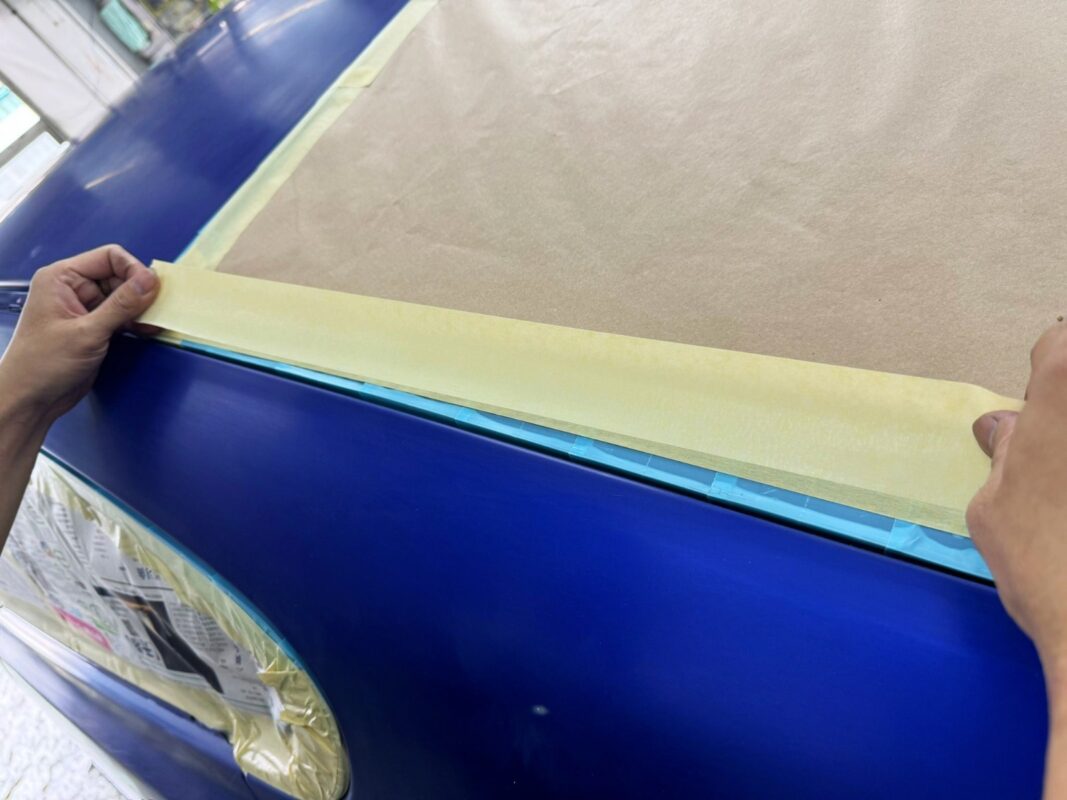 Non-painted surfaces masked on the Jaguar XF in preparation for spraying.