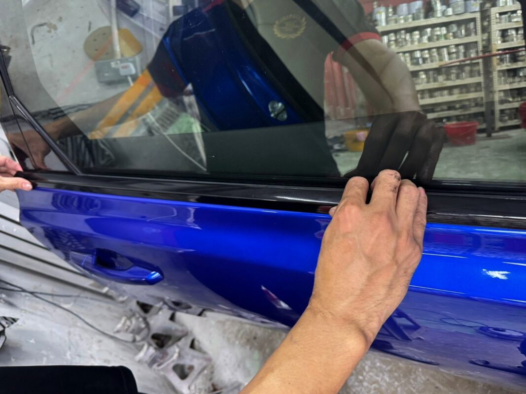 Machine-polishing the Jaguar XF's newly painted surface to bring up the shine.