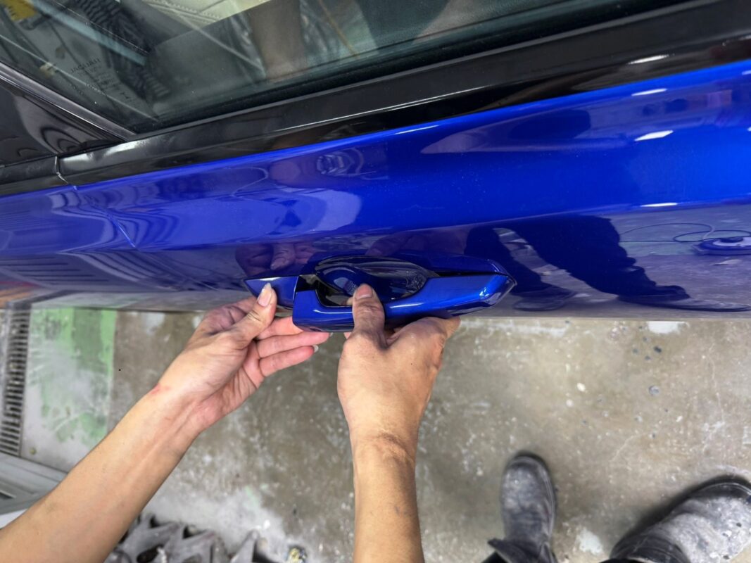 Final polish check on the freshly painted Jaguar XF.