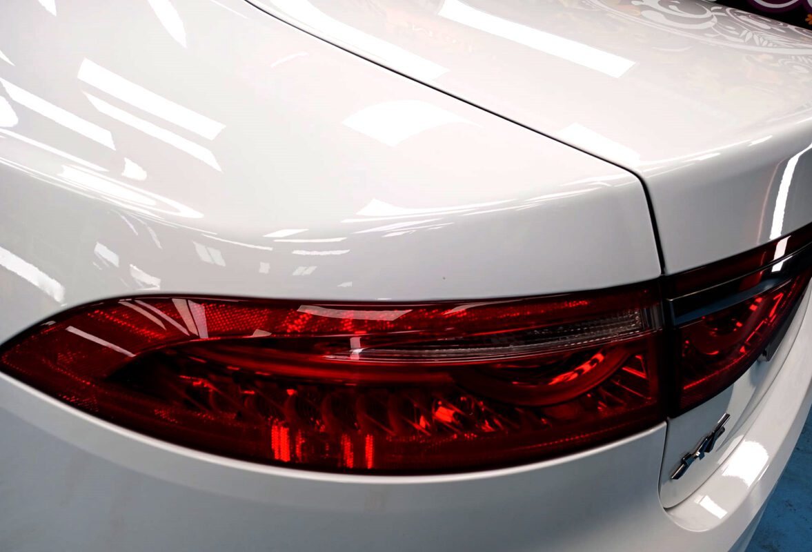 Rear quarter of the Jaguar XF, glossy and protected.