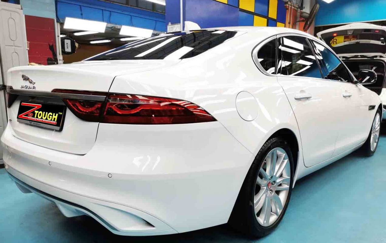 Rear quarter of the Jaguar XF, glossy and protected.