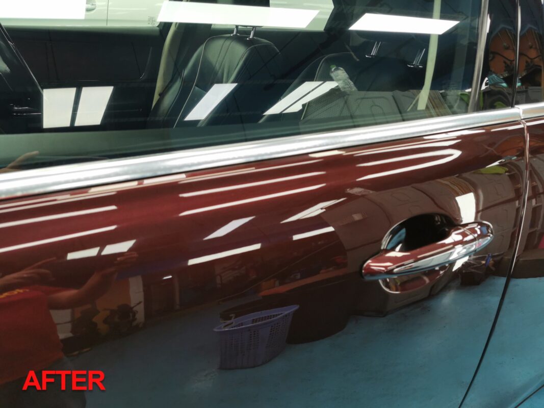 Compound-polishing the Jaguar XJ's hood to a mirror finish.