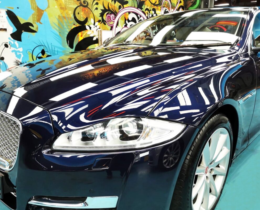 The blue Jaguar XJ from a side angle after the titanium coating.