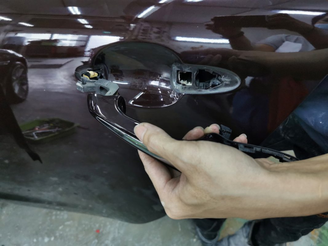 Car parts being dismantled from the XJL before spraying.