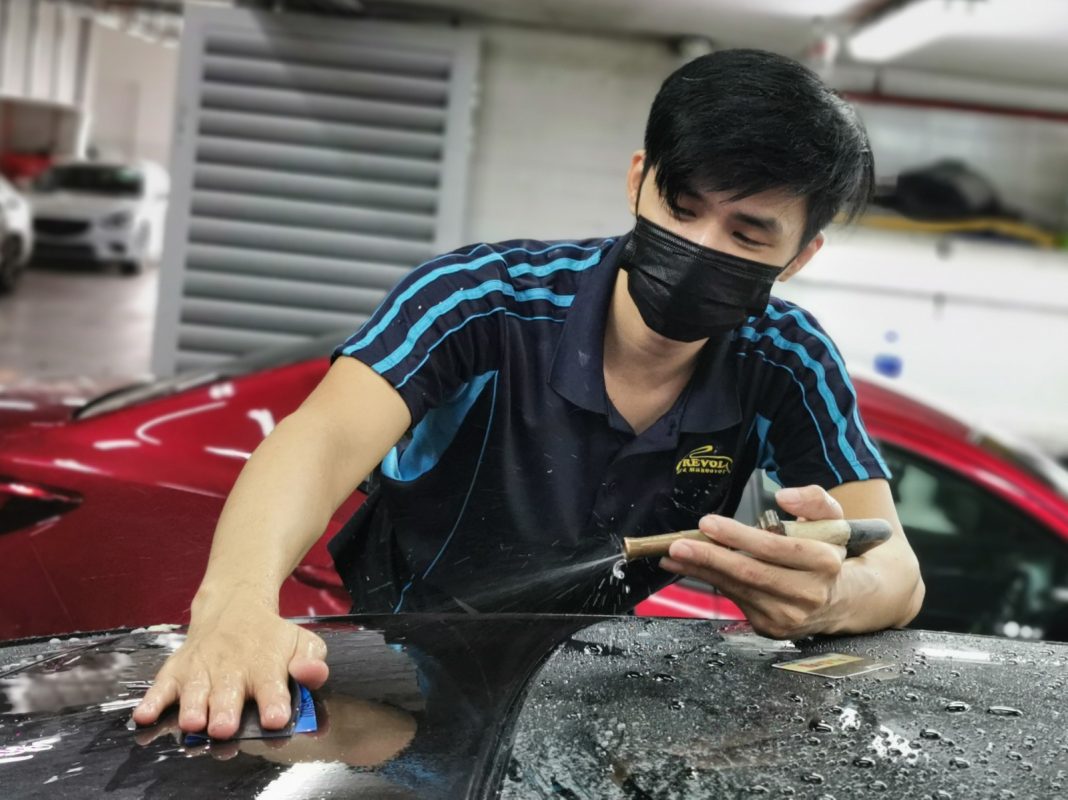 Wet-sanding the XJL's panels to smooth the surface.