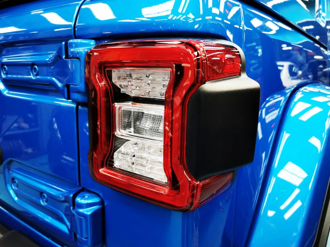 Bonnet of the Jeep Wrangler under workshop lighting.