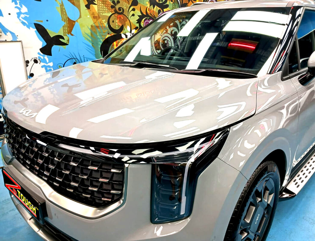 The Kia Carnival's coated paintwork under workshop lighting.