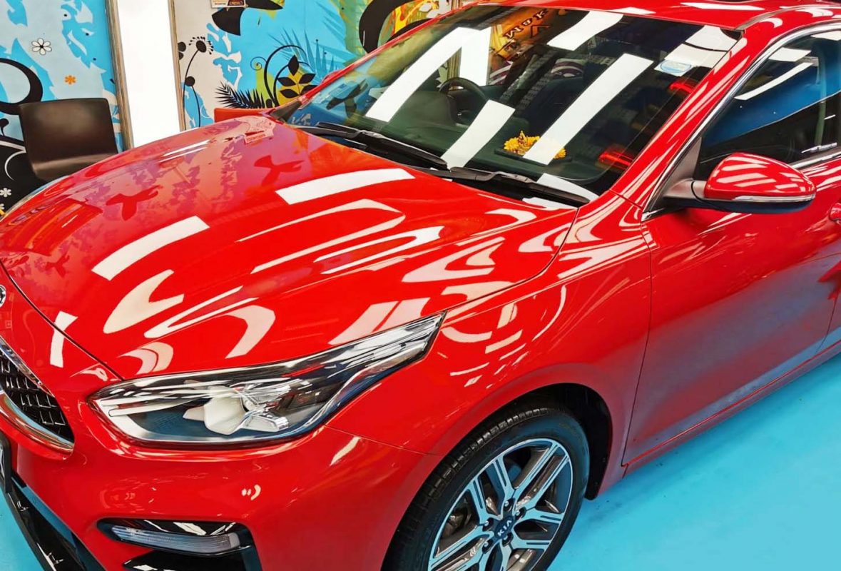 Side angle of the red Kia Cerato after the ceramic coating.