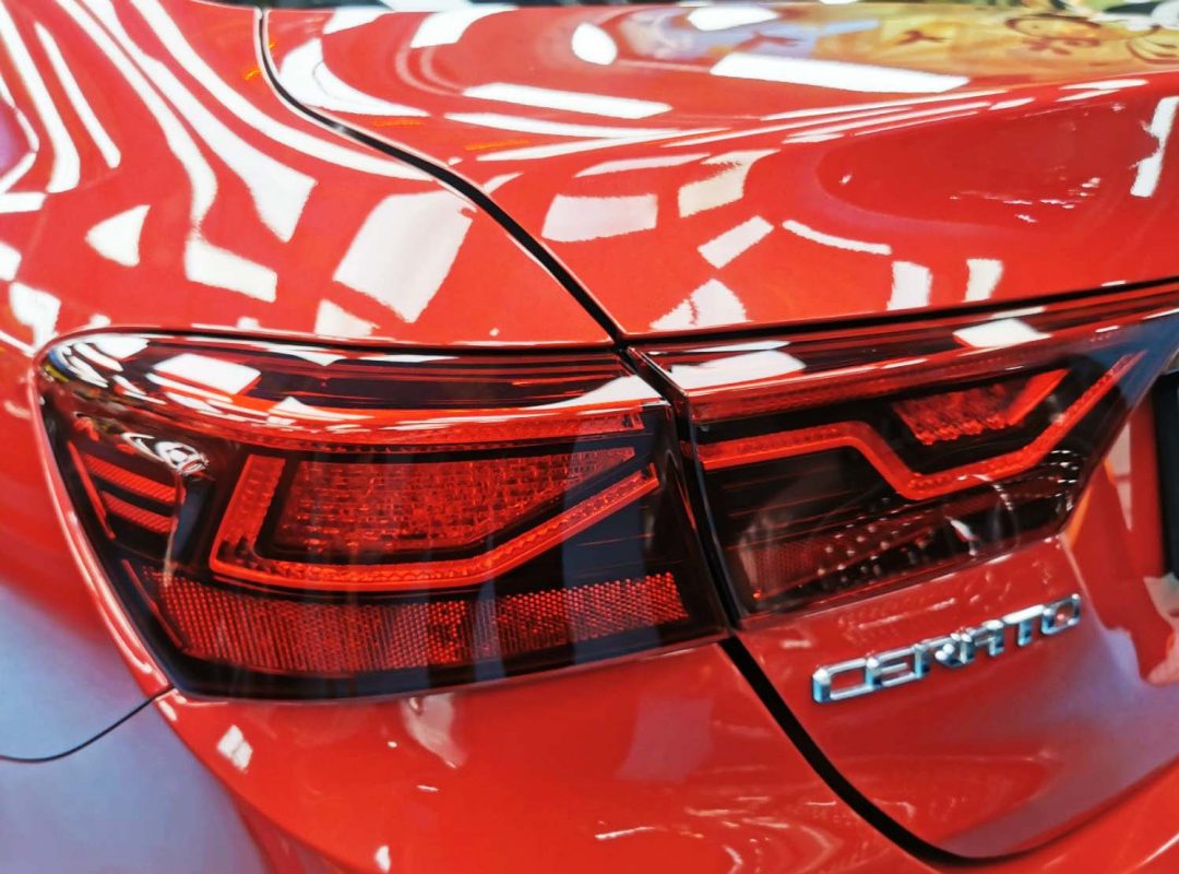Bonnet of the Kia Cerato under workshop lighting.