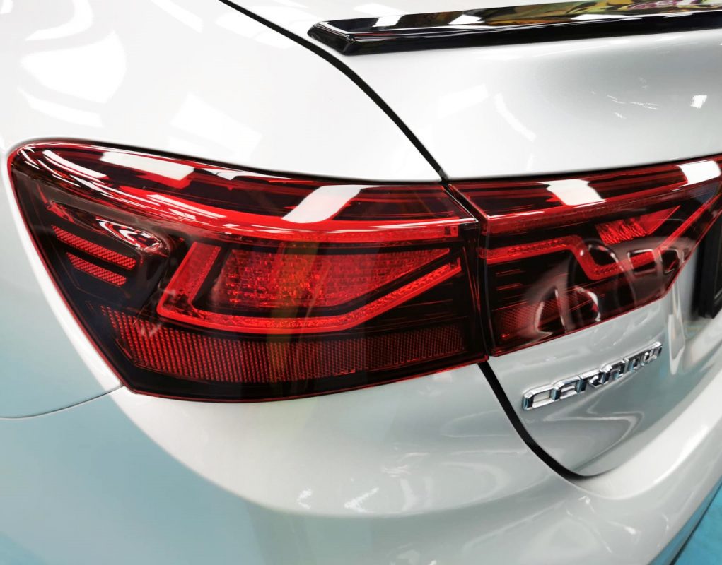 Bonnet of the Kia Cerato under workshop lighting.