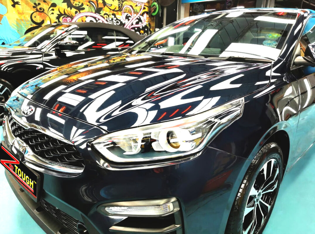 The Kia Cerato's coated paintwork under workshop lighting.