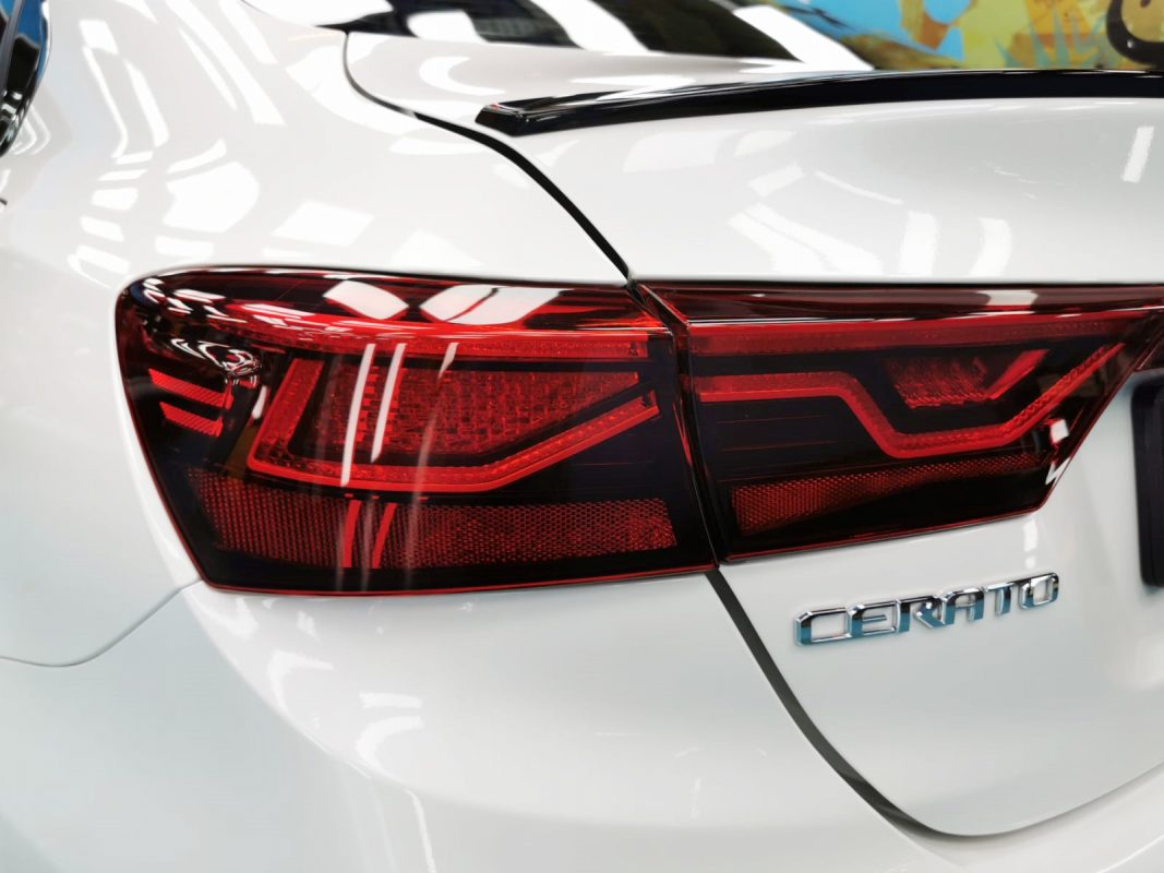 Coated bonnet of the Kia Cerato under workshop lighting.