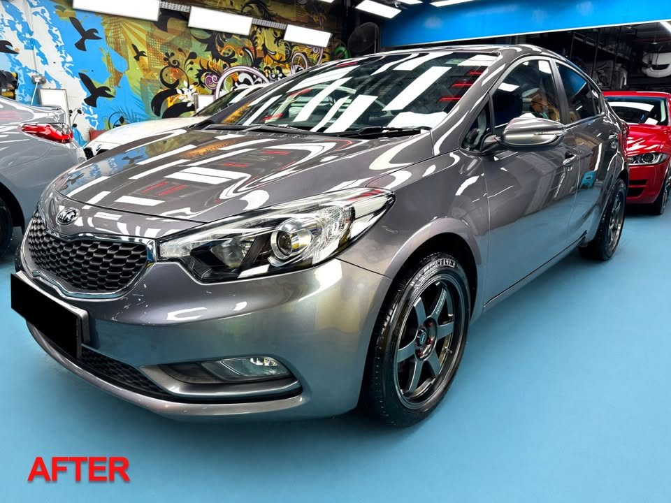 Finished grey Kia Forte K3 from the front three-quarter in the workshop, with a small AFTER label in the corner.