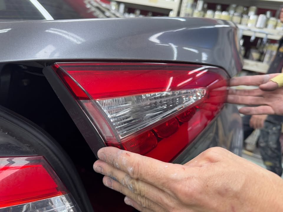 Tail light being removed from the rear of the car.