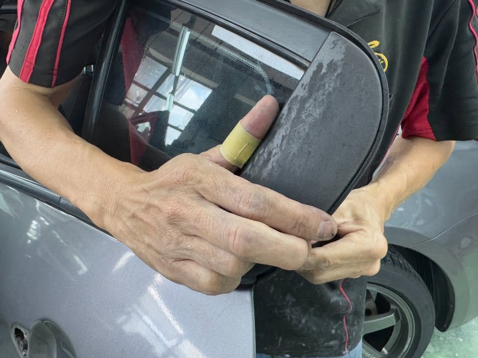 Side mirror being removed from the door.