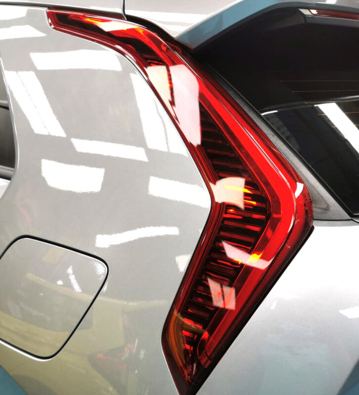 The coated bonnet of the Kia Niro under workshop lighting.