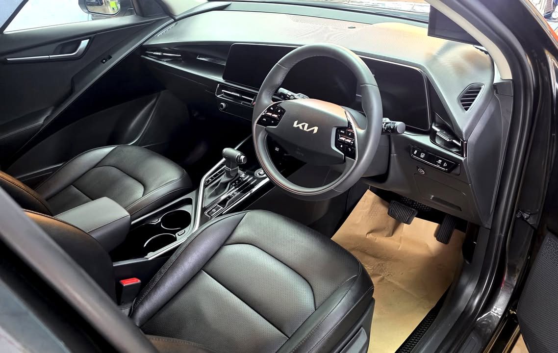 Cabin with black leather seats, steering wheel and dashboard.