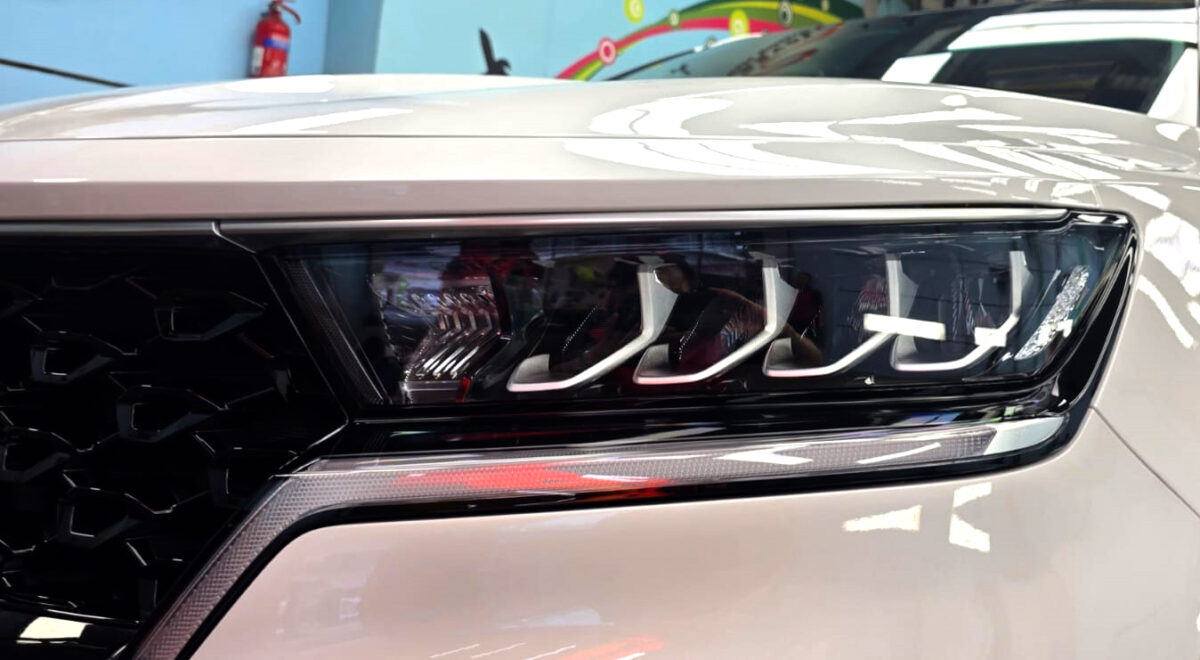 The Sorento's coated paintwork holding clean reflections.