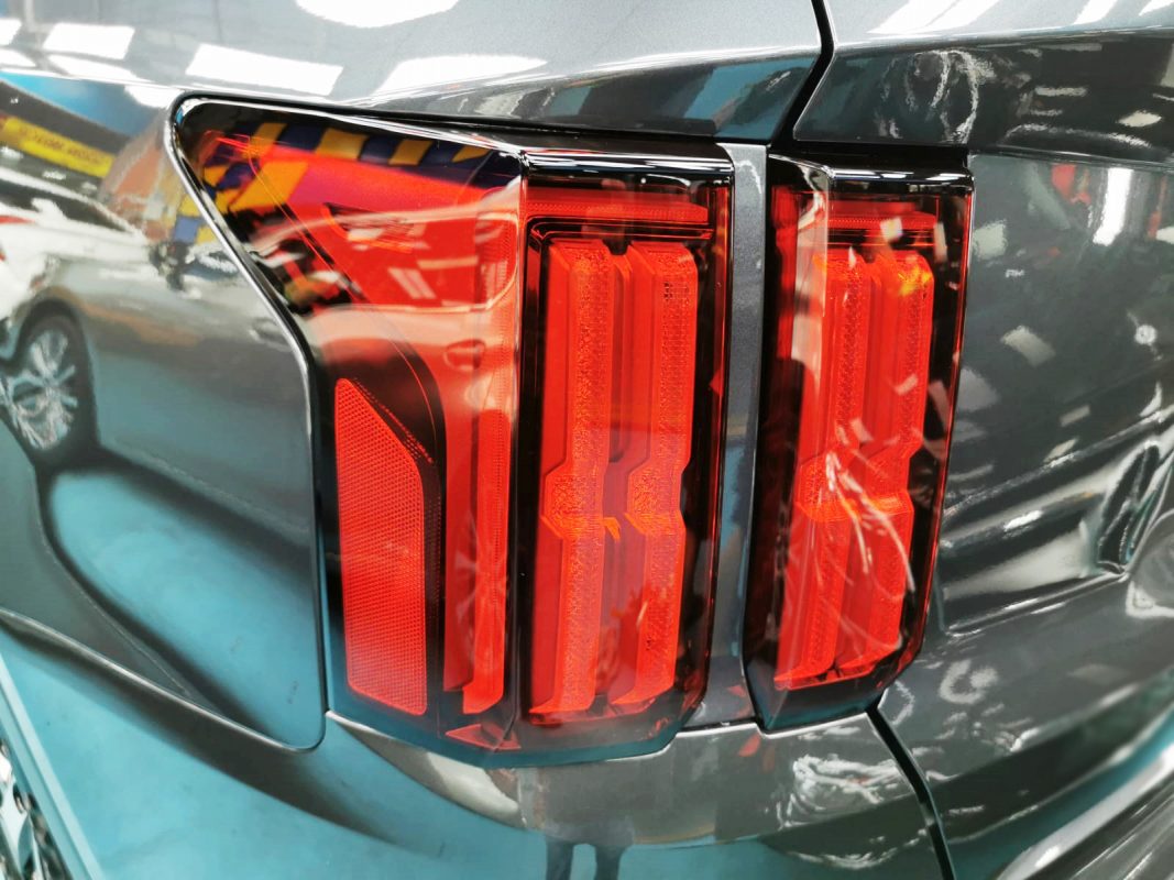 The coated bonnet of the Kia Sorento under workshop lighting.