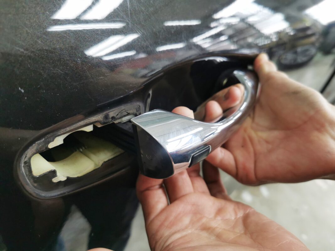 A door handle removed as the Kia Sorento is stripped down for the respray.
