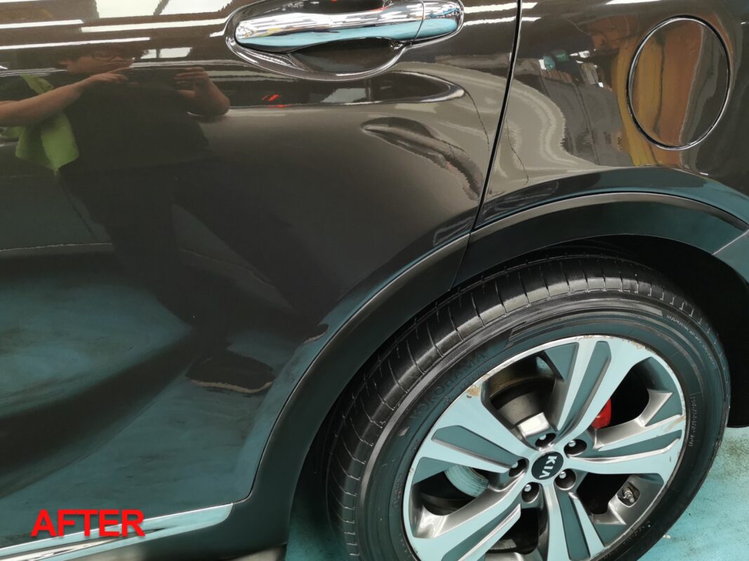 After: the same rear side panel, resprayed and finished to a deep gloss.