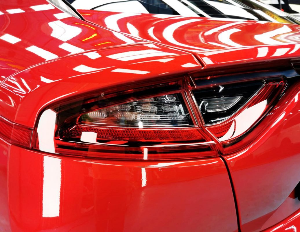 The coated bonnet of the Kia Stinger under workshop lighting.