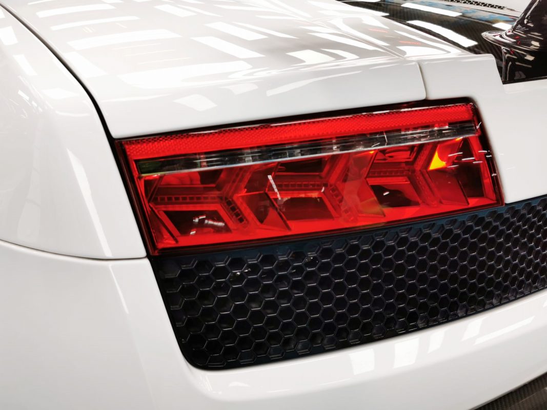 The coated bonnet of the Lamborghini Gallardo under workshop lighting.