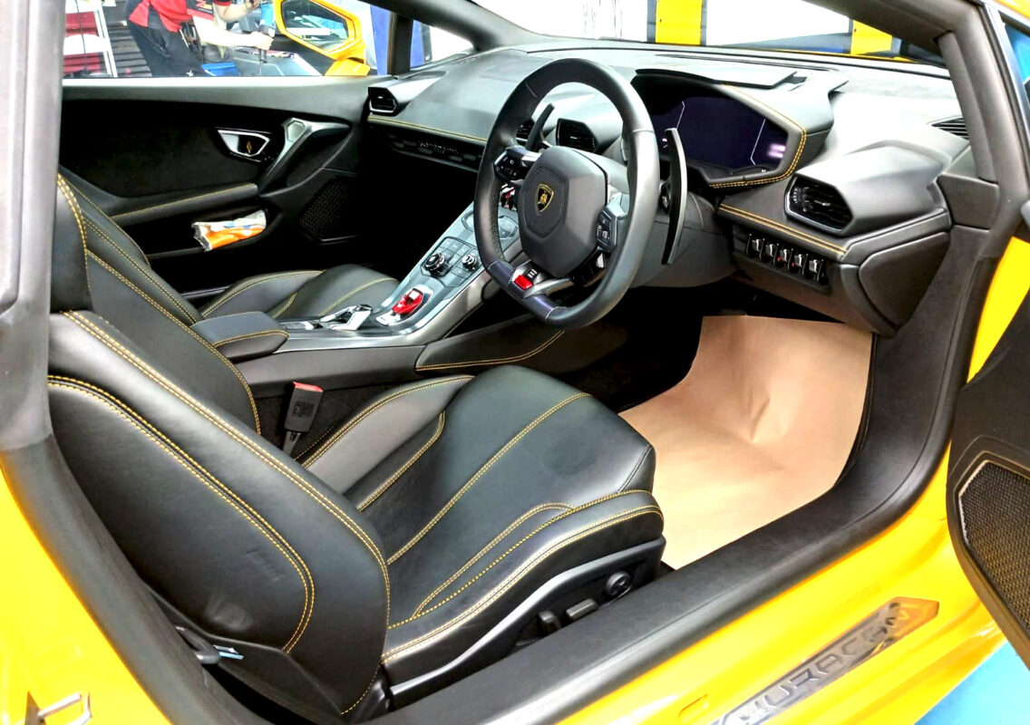 Reflections across the coated panels of the Lamborghini Huracan.
