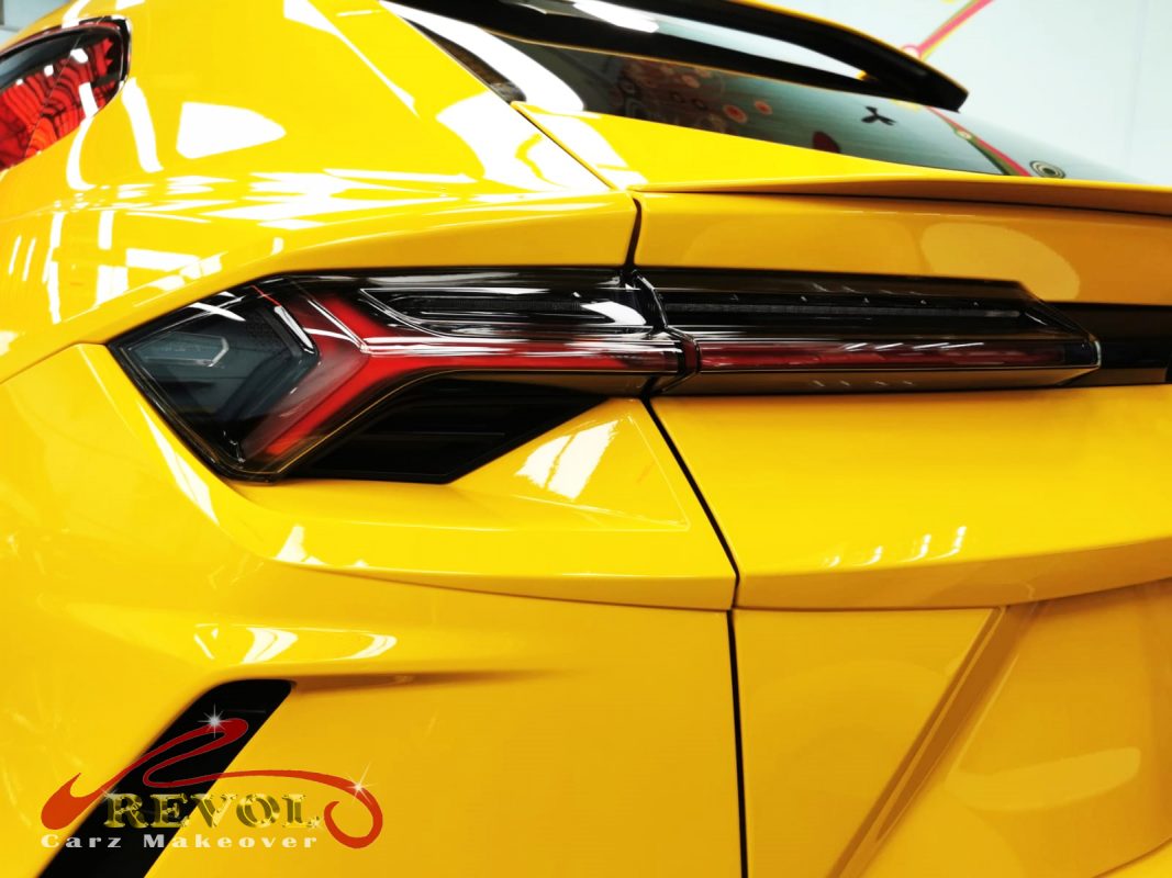 The coated bonnet of the Lamborghini Urus under workshop lighting.