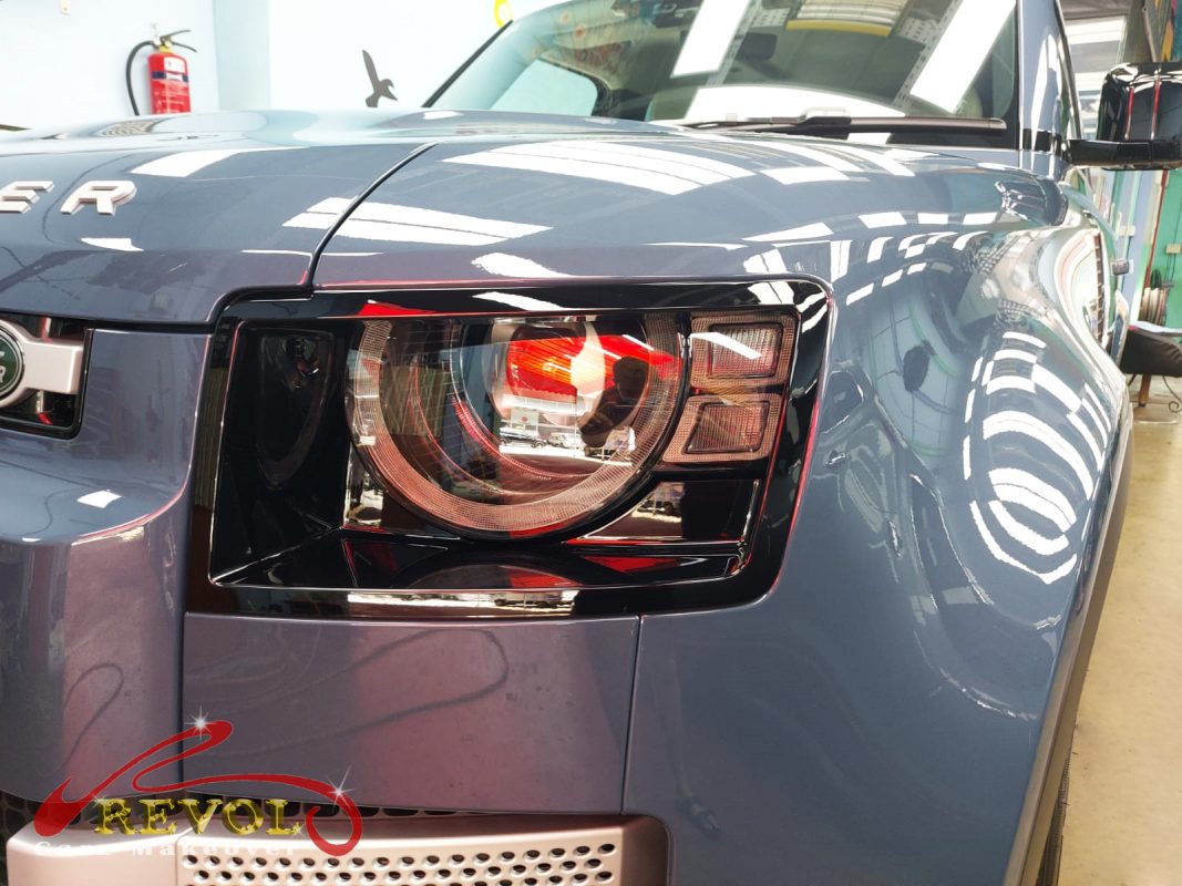 The Defender 110's coated paintwork showing clean reflections.